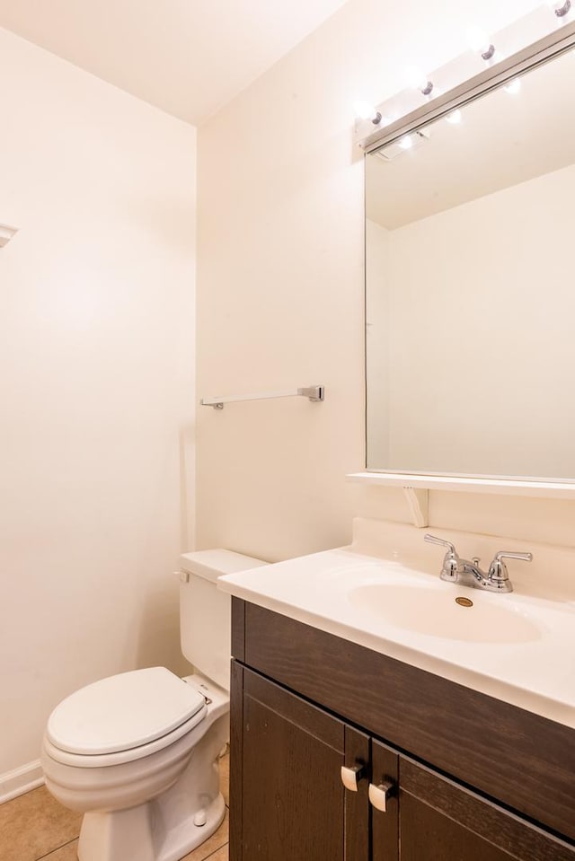 bathroom with vanity, toilet, and tile patterned flooring