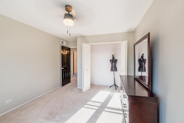 bedroom with light carpet, ceiling fan, and a closet