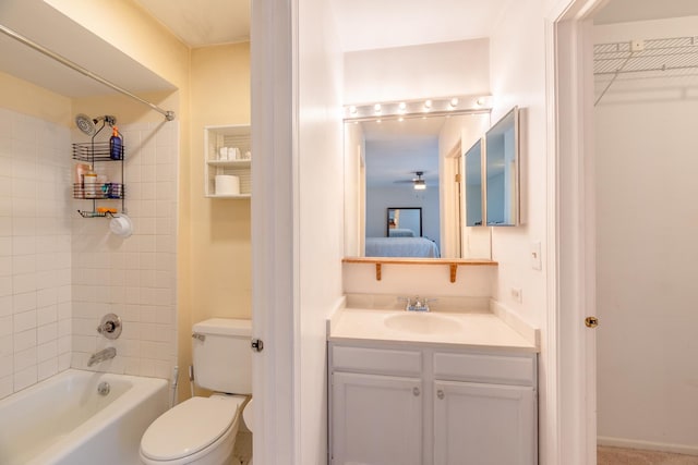 full bathroom with tiled shower / bath, vanity, and toilet