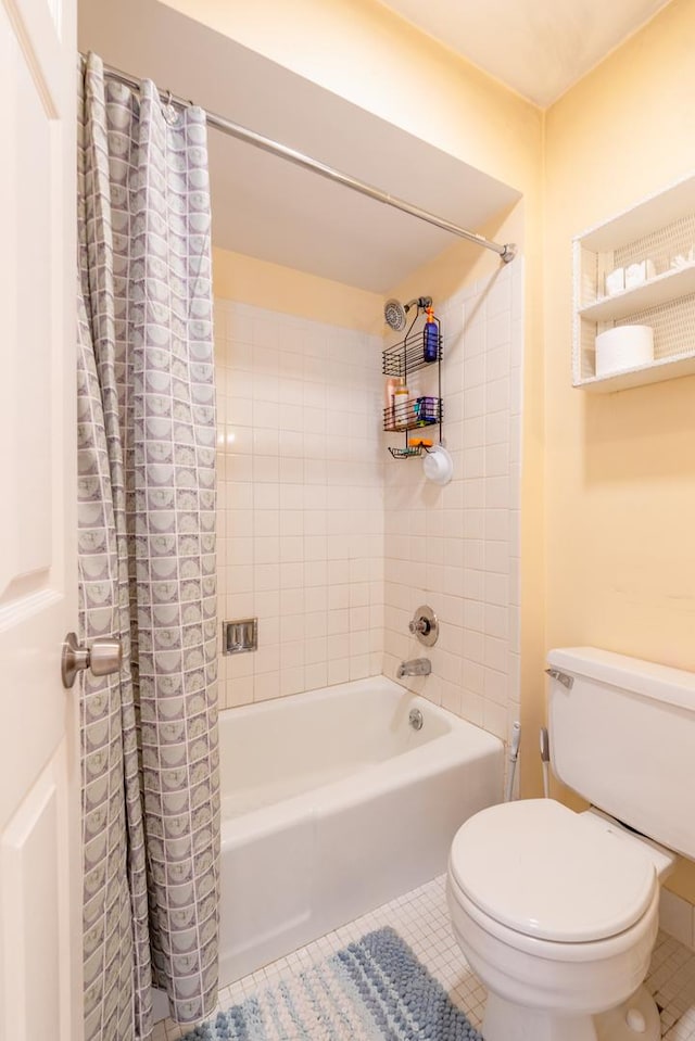 bathroom featuring shower / tub combo, tile patterned floors, and toilet