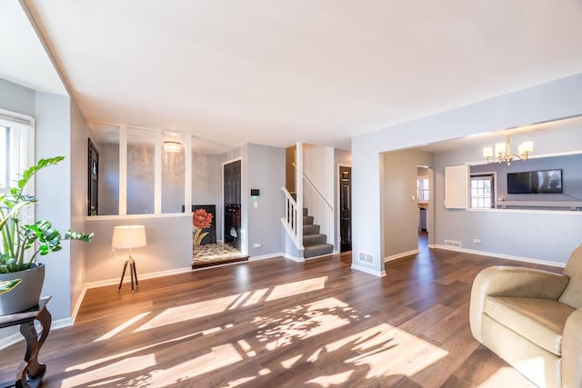 living room with wood-type flooring and a chandelier