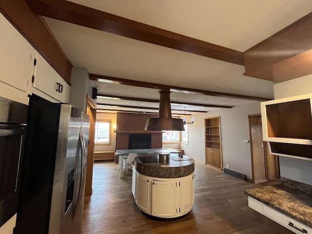 kitchen featuring white cabinetry, dark hardwood / wood-style flooring, beamed ceiling, and stainless steel refrigerator with ice dispenser