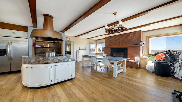 kitchen featuring white cabinetry, black electric cooktop, light hardwood / wood-style floors, and stainless steel fridge with ice dispenser