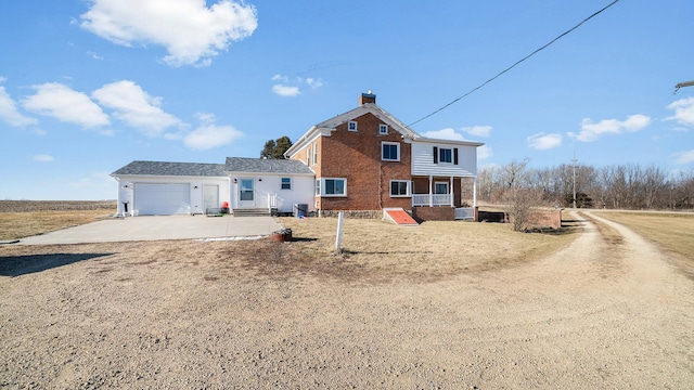 view of front of property with central AC and a garage