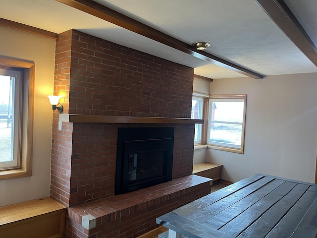 unfurnished living room featuring a fireplace and beam ceiling