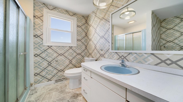 bathroom with walk in shower, vanity, toilet, and tile walls