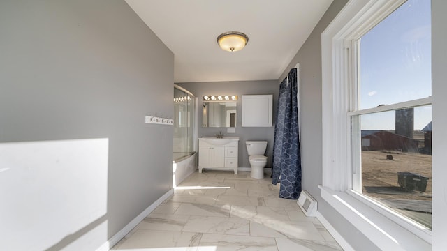 full bathroom featuring vanity, shower / tub combo, and toilet