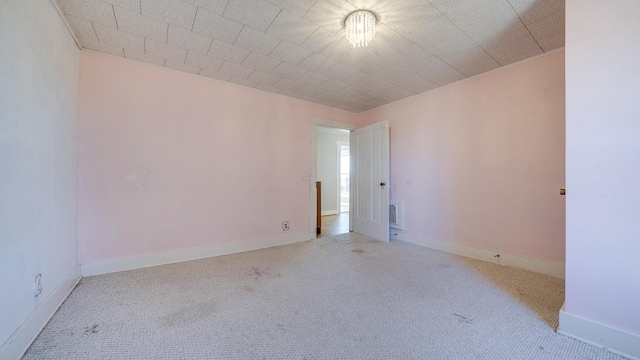 spare room with light carpet