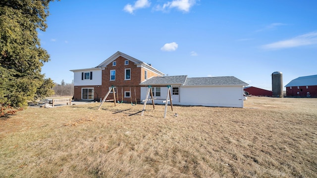 back of house with a lawn