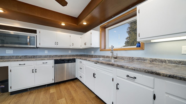 kitchen with sink, ceiling fan, white cabinetry, stainless steel appliances, and light hardwood / wood-style floors