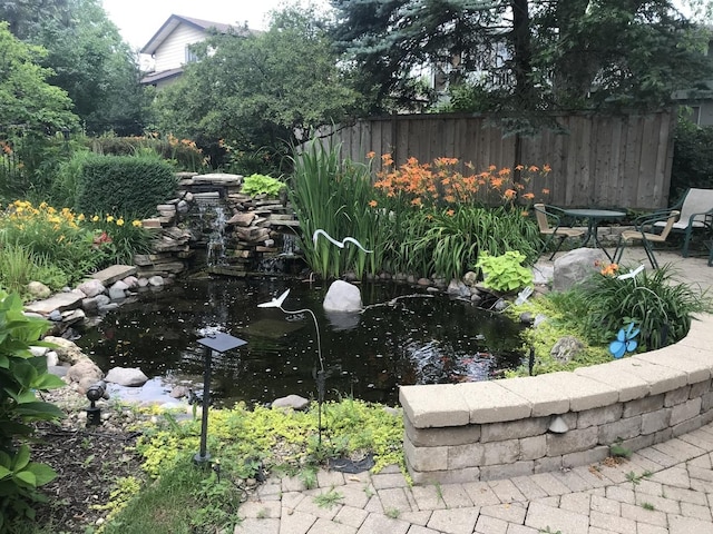 view of yard featuring a small pond