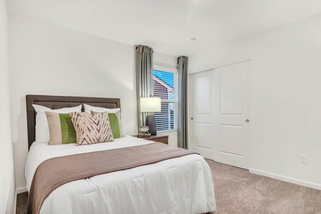 carpeted bedroom with a closet