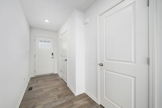 doorway to outside with wood-type flooring