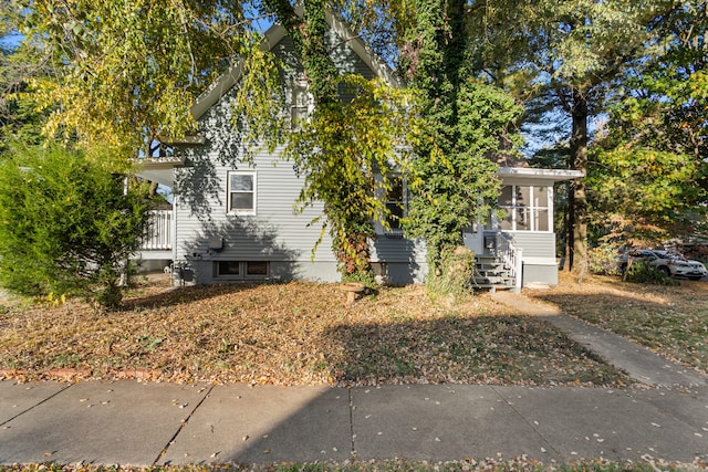 view of side of home with a sunroom