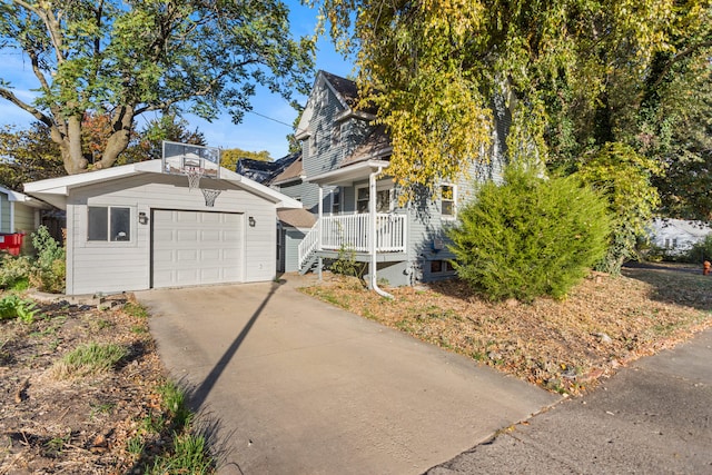 view of front of house featuring an outbuilding, concrete driveway, and a garage