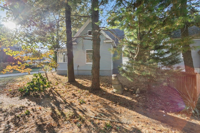 view of side of property featuring fence