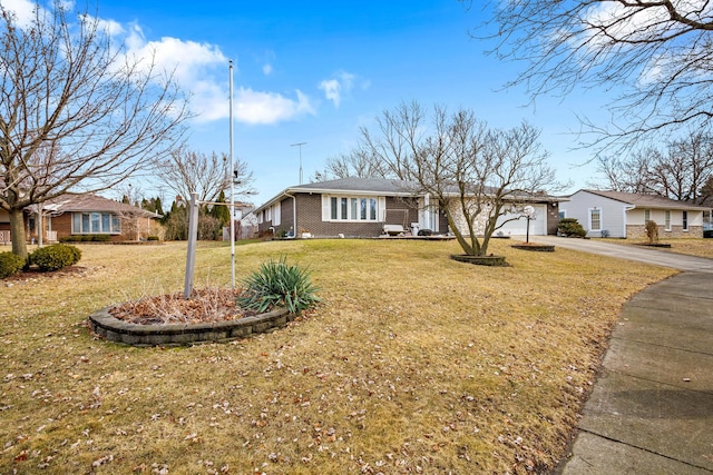 single story home featuring a garage and a front yard