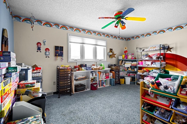 rec room featuring ceiling fan, carpet, and a textured ceiling