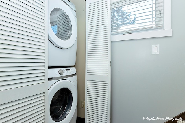 clothes washing area with stacked washer / drying machine