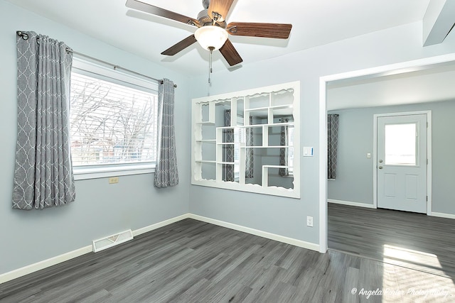 spare room featuring dark hardwood / wood-style floors and ceiling fan