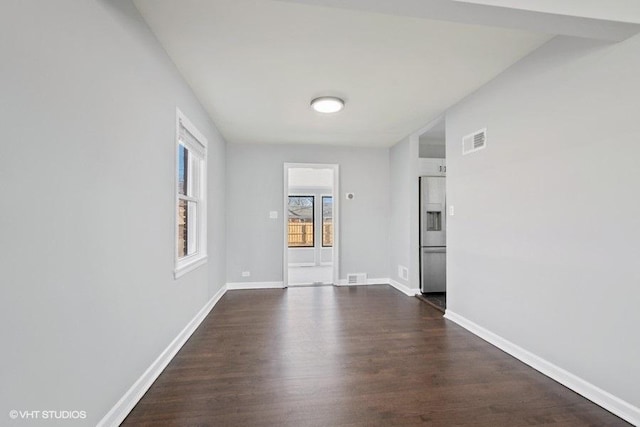 empty room with dark hardwood / wood-style flooring