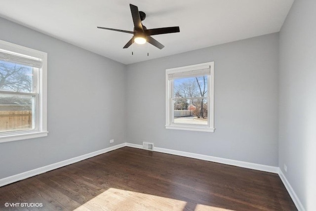 spare room featuring ceiling fan and dark hardwood / wood-style floors