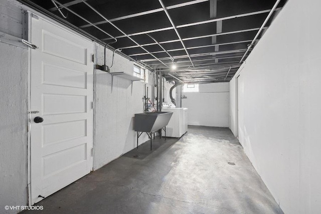 basement featuring sink and washer and clothes dryer