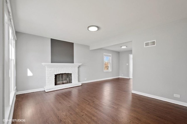 unfurnished living room with dark hardwood / wood-style floors and a fireplace