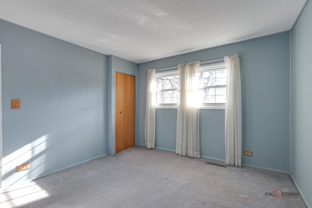 spare room with light carpet