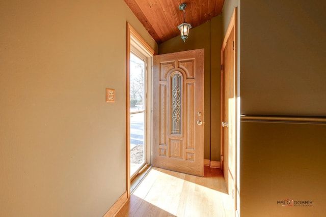 doorway to outside with lofted ceiling, light hardwood / wood-style flooring, and wooden ceiling