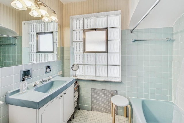 bathroom with vanity, tile walls, tile patterned floors, and bathing tub / shower combination