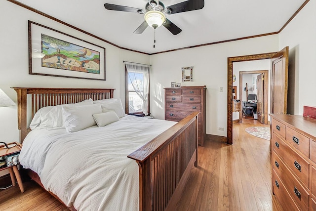 bedroom featuring ornamental molding, ceiling fan, and light wood-type flooring