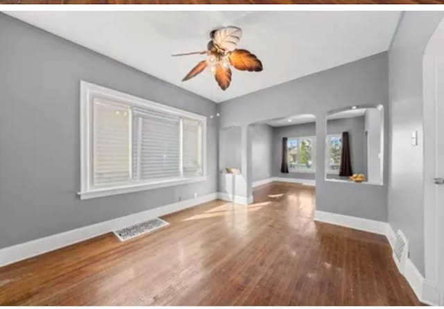 spare room with hardwood / wood-style floors and ceiling fan