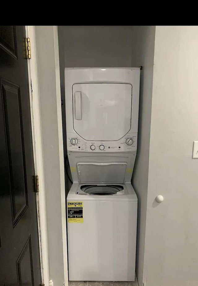 laundry area featuring stacked washer / dryer