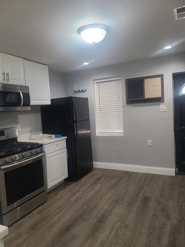 kitchen featuring white cabinetry, dark hardwood / wood-style floors, and appliances with stainless steel finishes