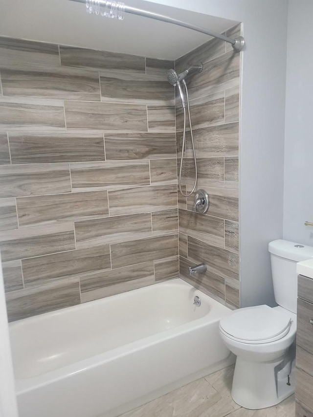 bathroom featuring toilet and tiled shower / bath combo