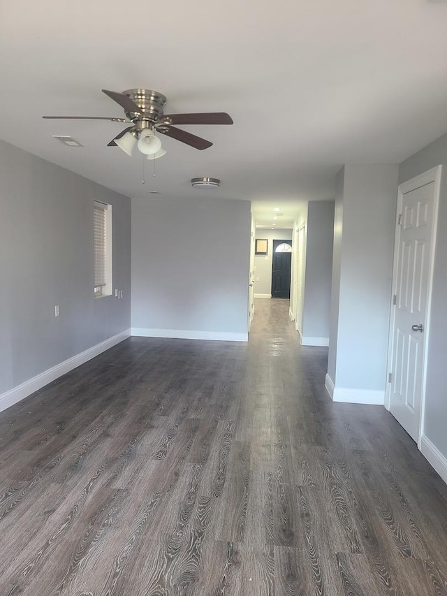 empty room featuring dark hardwood / wood-style floors and ceiling fan