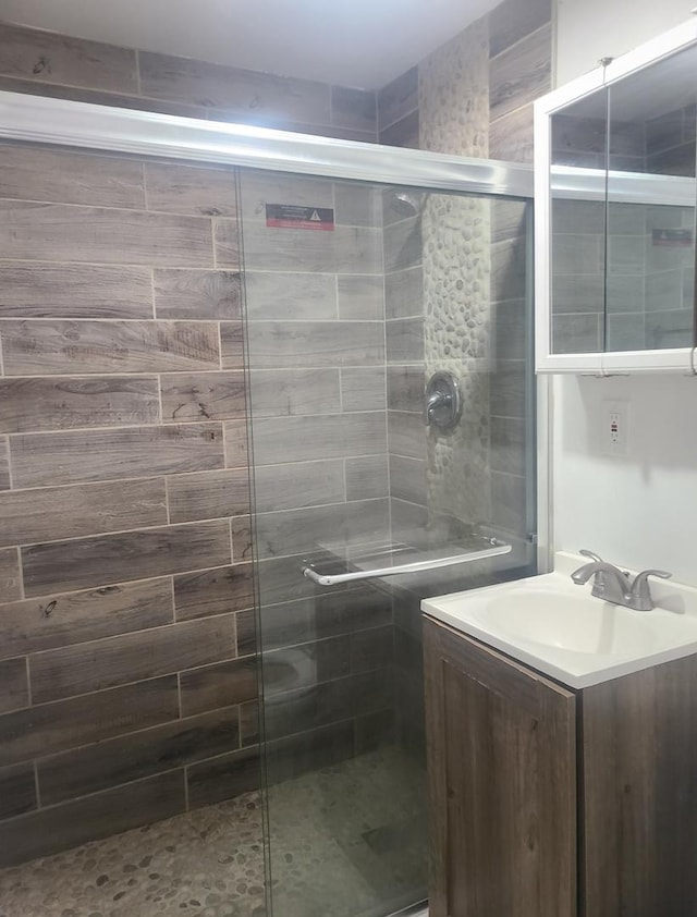 bathroom featuring vanity and an enclosed shower