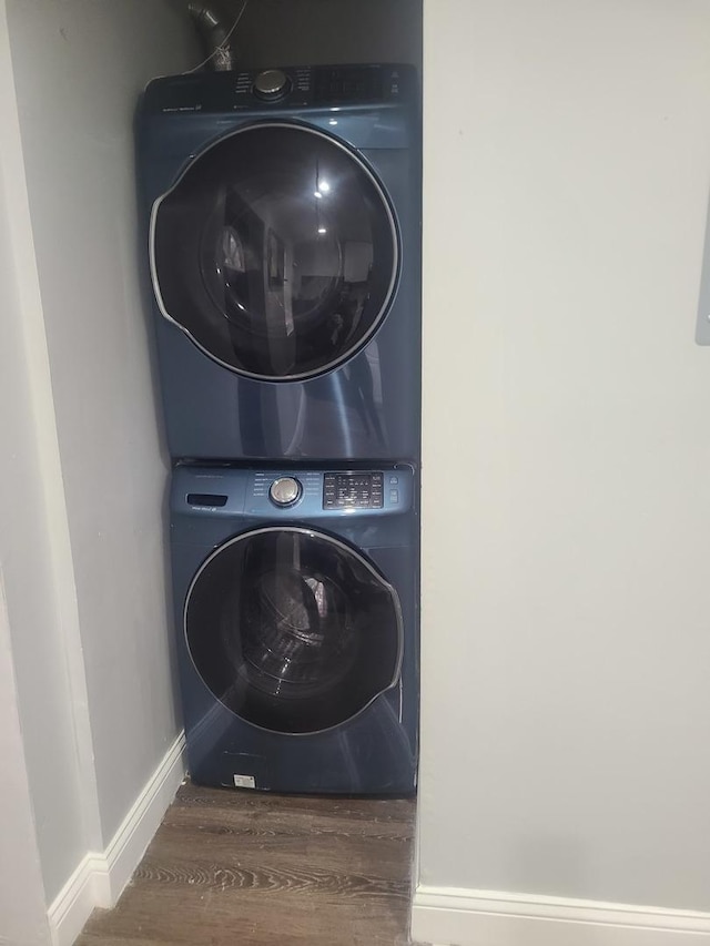 washroom featuring stacked washer and clothes dryer