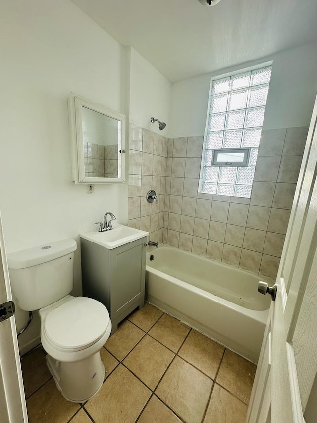 full bathroom with vanity, tile patterned flooring, tiled shower / bath combo, and toilet