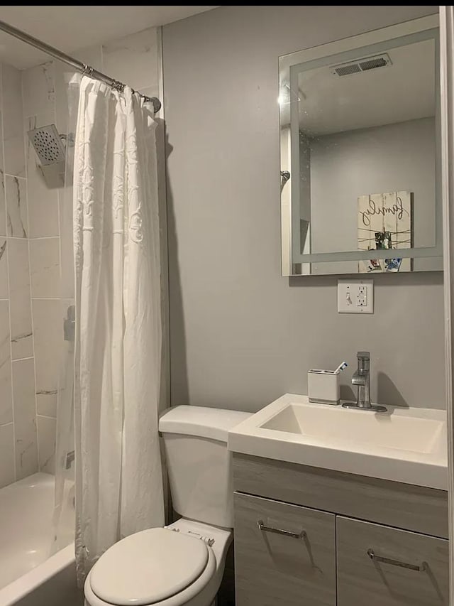 full bathroom featuring vanity, shower / tub combo, and toilet