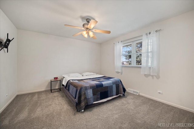 carpeted bedroom featuring baseboards, visible vents, and ceiling fan