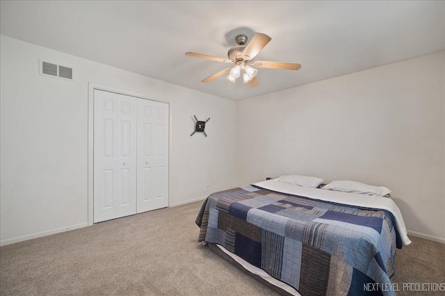 carpeted bedroom featuring a closet, visible vents, a ceiling fan, and baseboards