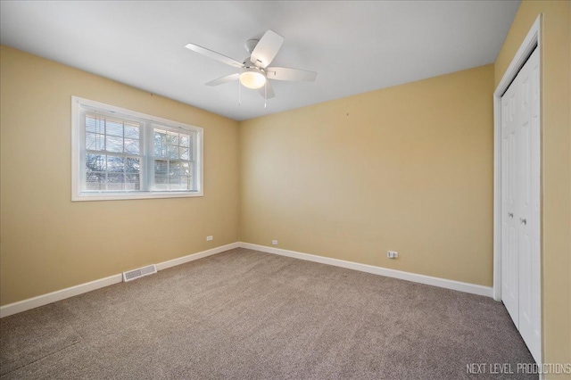 unfurnished bedroom with a ceiling fan, baseboards, visible vents, carpet floors, and a closet