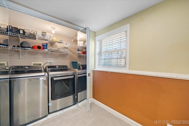 laundry room with baseboards, light colored carpet, washing machine and dryer, and laundry area