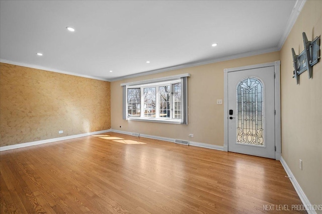 entryway featuring visible vents, ornamental molding, wood finished floors, recessed lighting, and baseboards