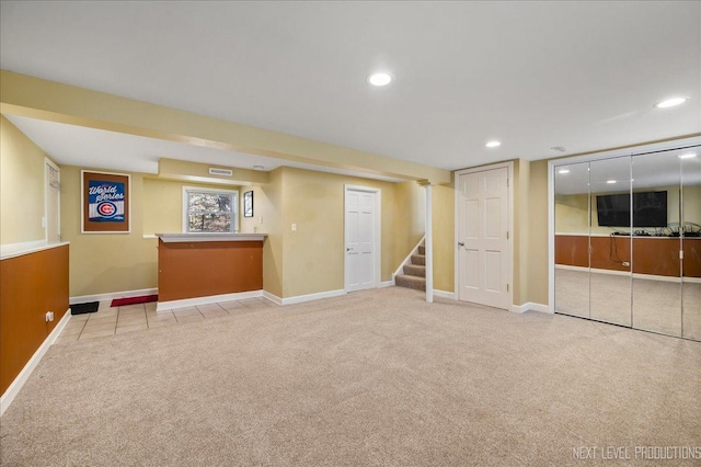 basement featuring recessed lighting, stairway, carpet floors, and baseboards