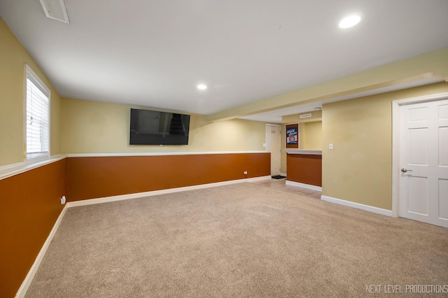 below grade area featuring recessed lighting, baseboards, visible vents, and light carpet