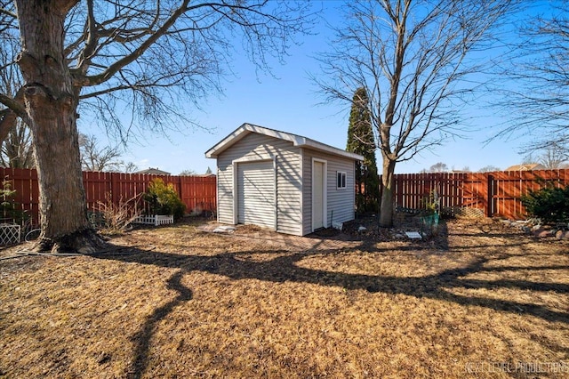 garage with a storage shed and fence