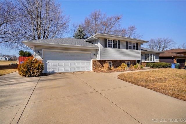 tri-level home featuring a front yard, brick siding, concrete driveway, and an attached garage